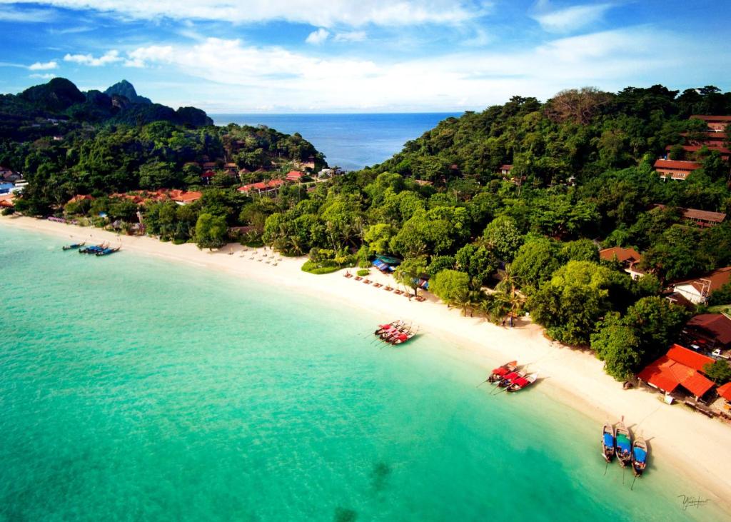 an aerial view of a beach with boats in the water at Zeavola Resort in Phi Phi Islands