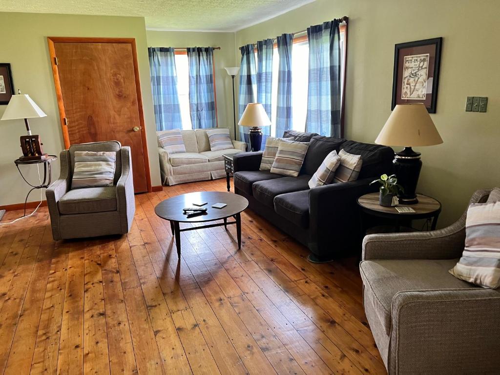a living room with a couch and chairs and a table at White Caps Motel in Port Clinton
