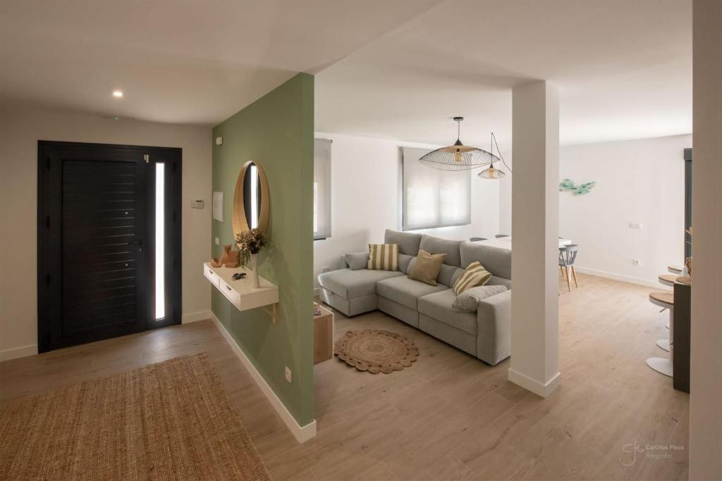 a living room with a couch and a mirror at Casa Viturna in O Grove