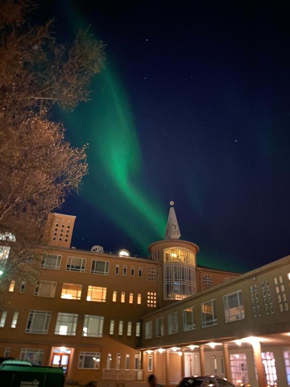 a green light in the sky above a building at Hostel B47 in Reykjavík