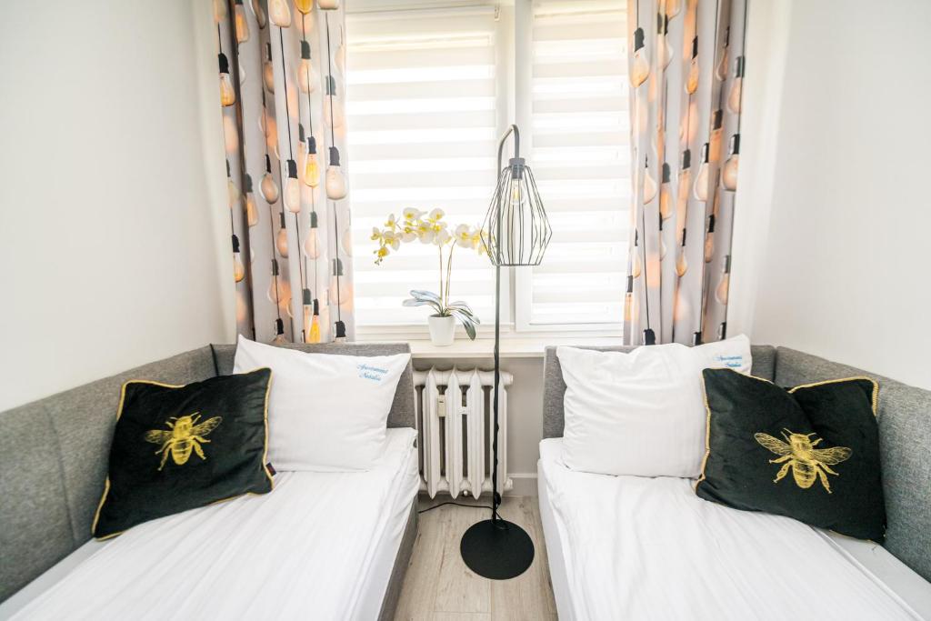 Posteľ alebo postele v izbe v ubytovaní Apartament Natalia