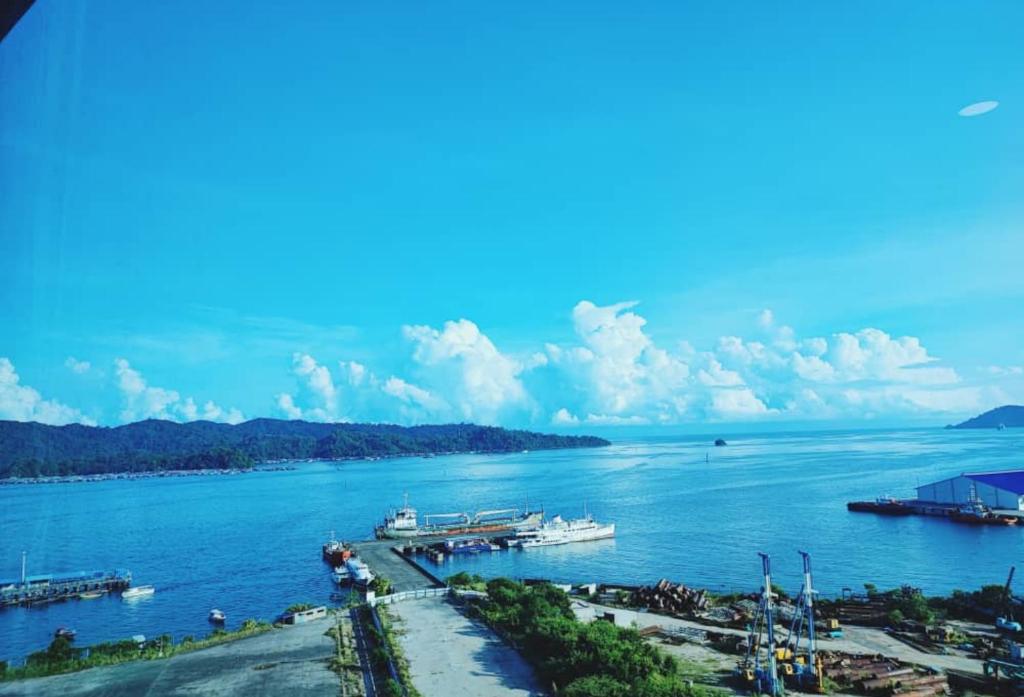 a view of a river with boats in the water at JESSELTON QUAY SEA VIEW in Kota Kinabalu