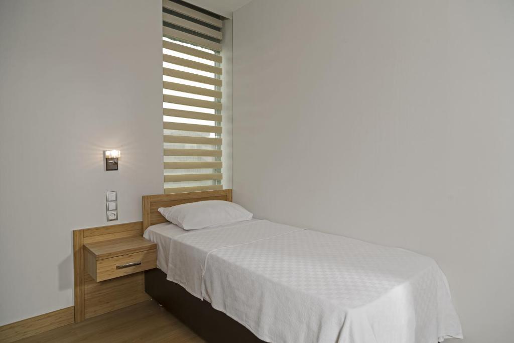 Postel nebo postele na pokoji v ubytování Demir Suite Hotel