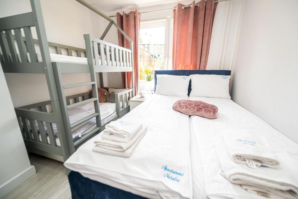 Posteľ alebo postele v izbe v ubytovaní Apartament Natalia