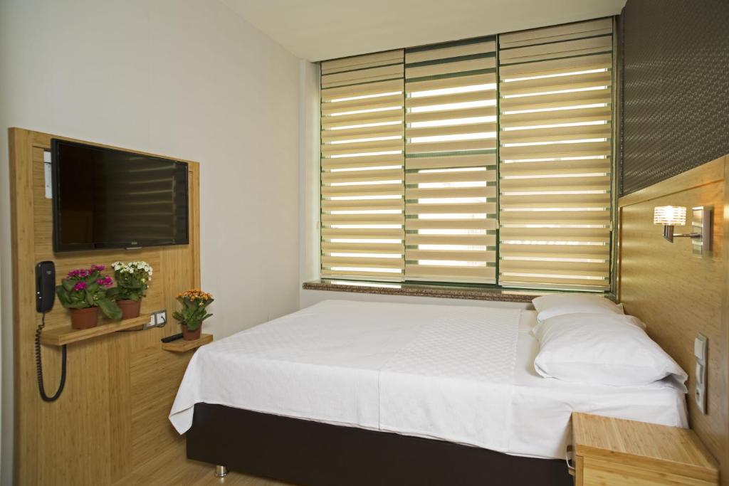 Postel nebo postele na pokoji v ubytování Demir Suite Hotel