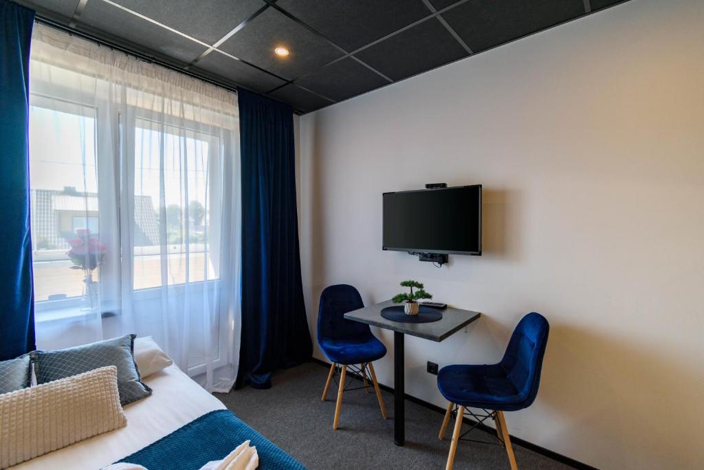 TV a/nebo společenská místnost v ubytování Apartments24 Ilu