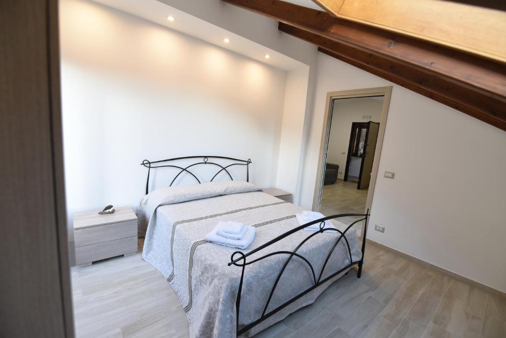 a bedroom with a large bed and a mirror at Casa Vacanze Andromeda in Agerola