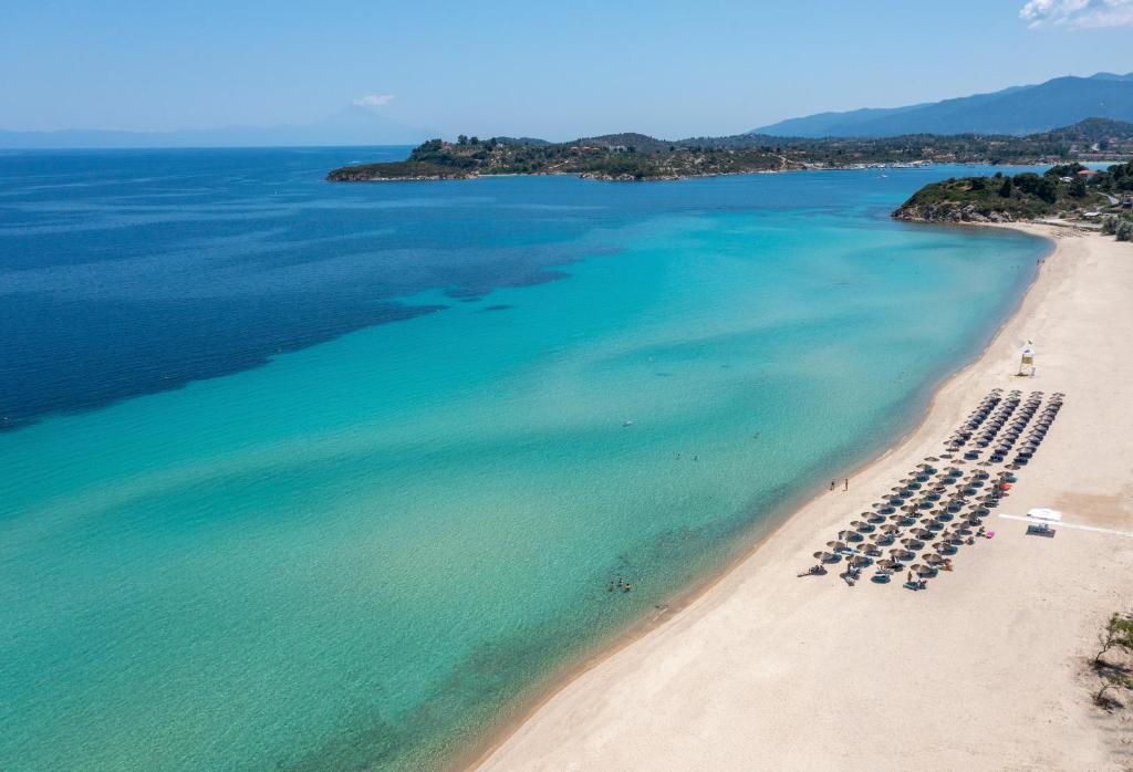 an aerial view of a beach with tables and chairs at Antigoni Seaside Resort in Ormos Panagias