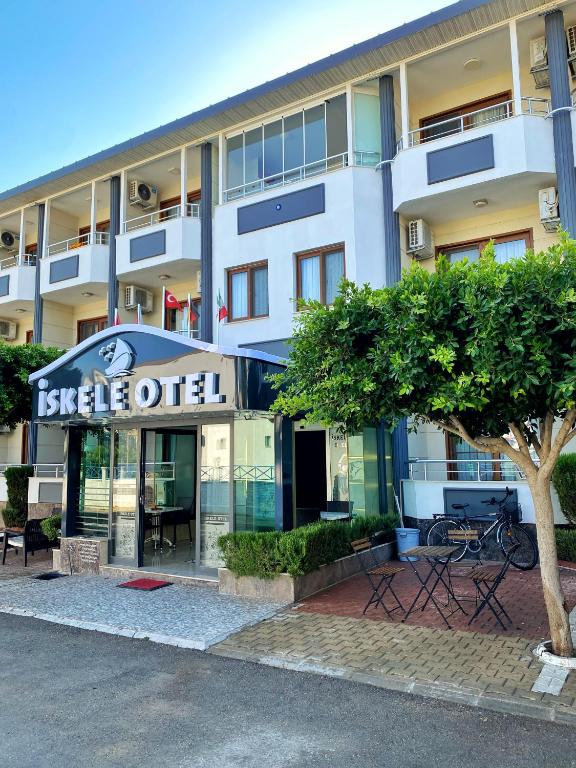 a building with a sign for a hotel at İskele Otel in Tasucu