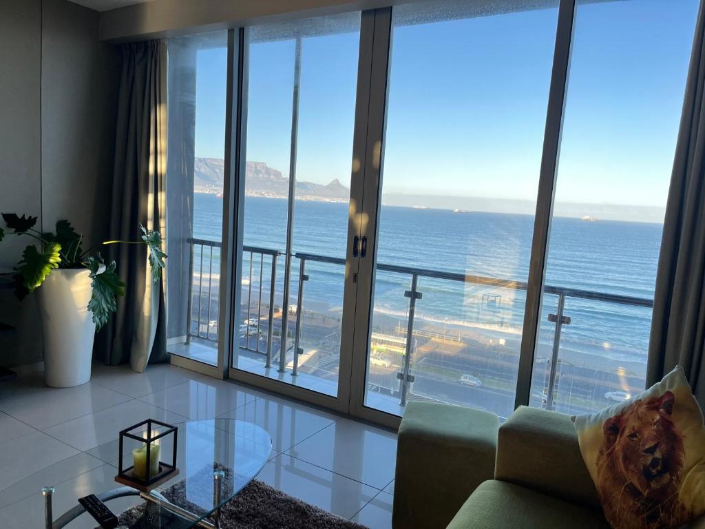 a living room with a view of the ocean at Sea&Mountain view by Caline VIP in Cape Town