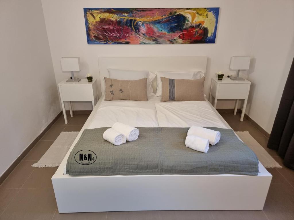 Postel nebo postele na pokoji v ubytování N&N Apartments and Rooms by Locap Group