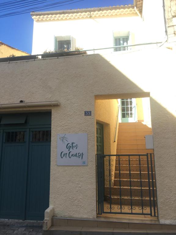 a house with a sign on the side of it at Gites Còr Causy OLEANDER in Causses-et-Veyran