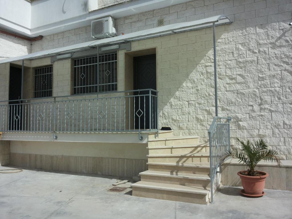 a building with a staircase and a balcony at Residence Via Del Mare in Galatone