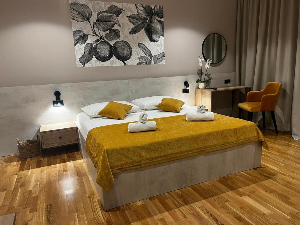 a bedroom with a bed with two towels on it at MEMORI bed&breakfast in Rab