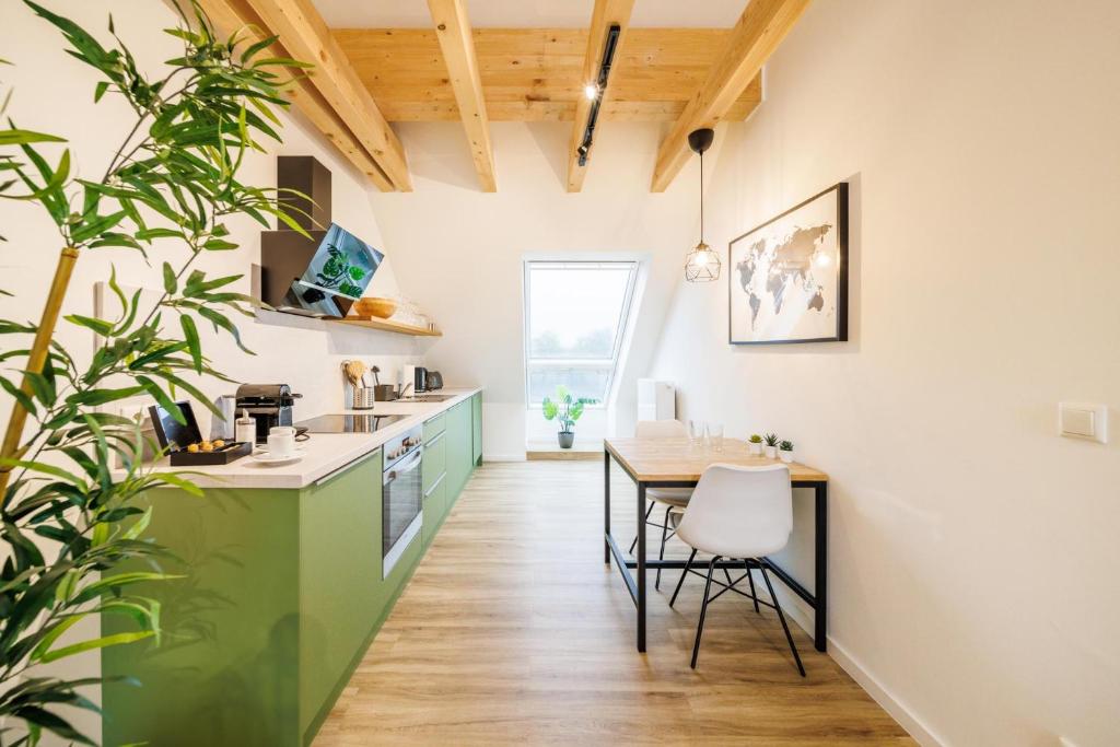 a kitchen and dining room with a table and chairs at Glück Auf Appartements Rembrandtstraße Essen in Essen