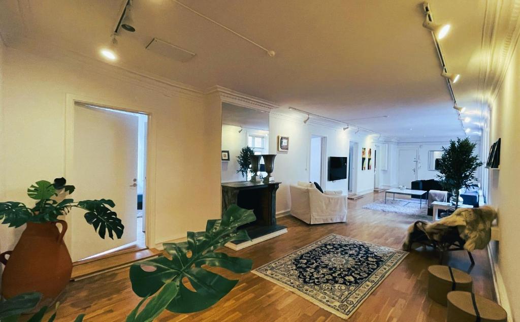 a living room with potted plants on the floor at ApartmentInCopenhagen Apartment 1502 in Copenhagen