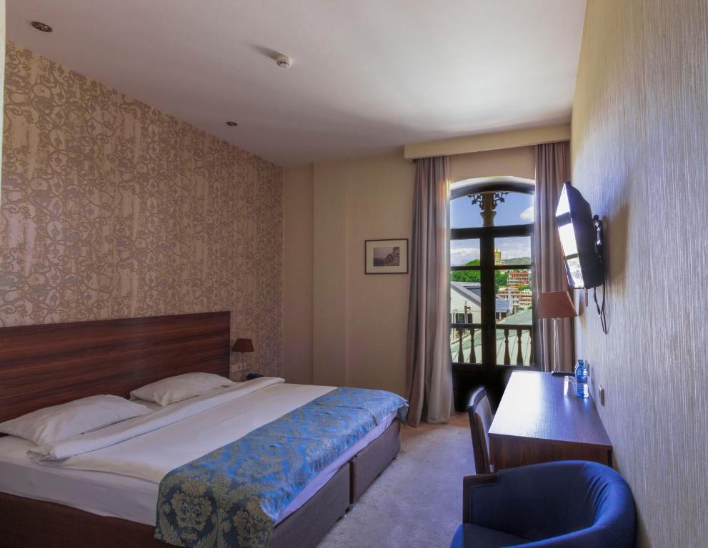 Postel nebo postele na pokoji v ubytování Old Meidan Tbilisi By Urban Hotels