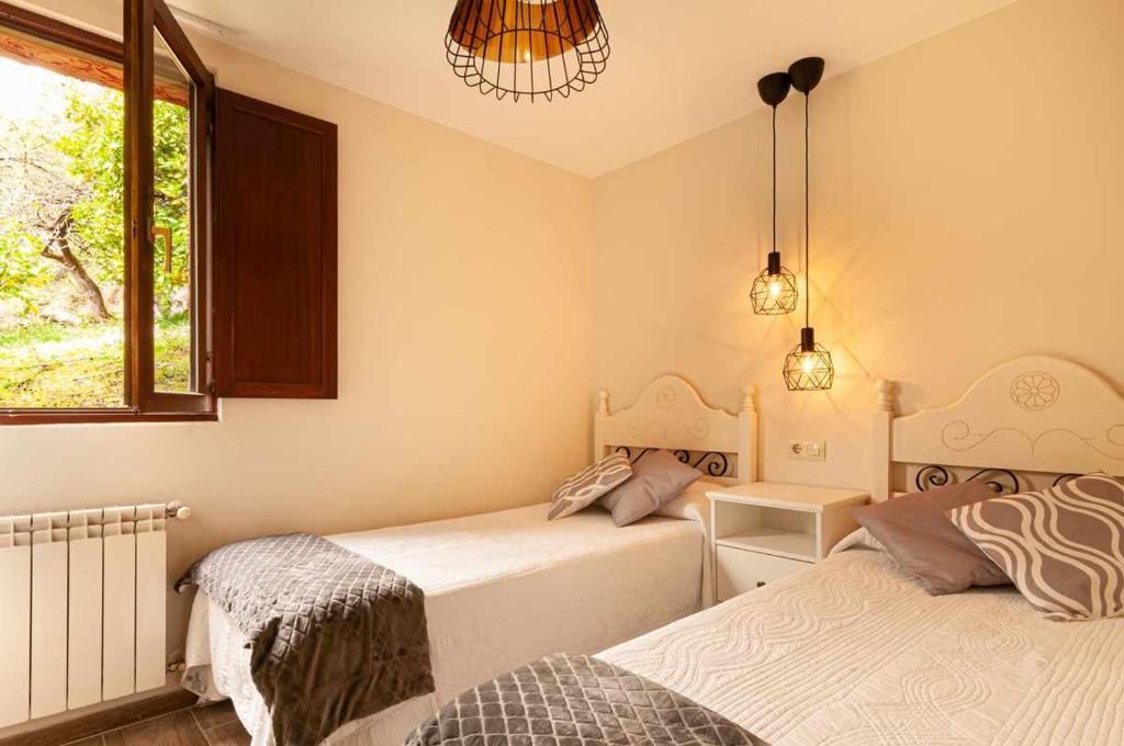 A bed or beds in a room at La casina de cuevas del agua