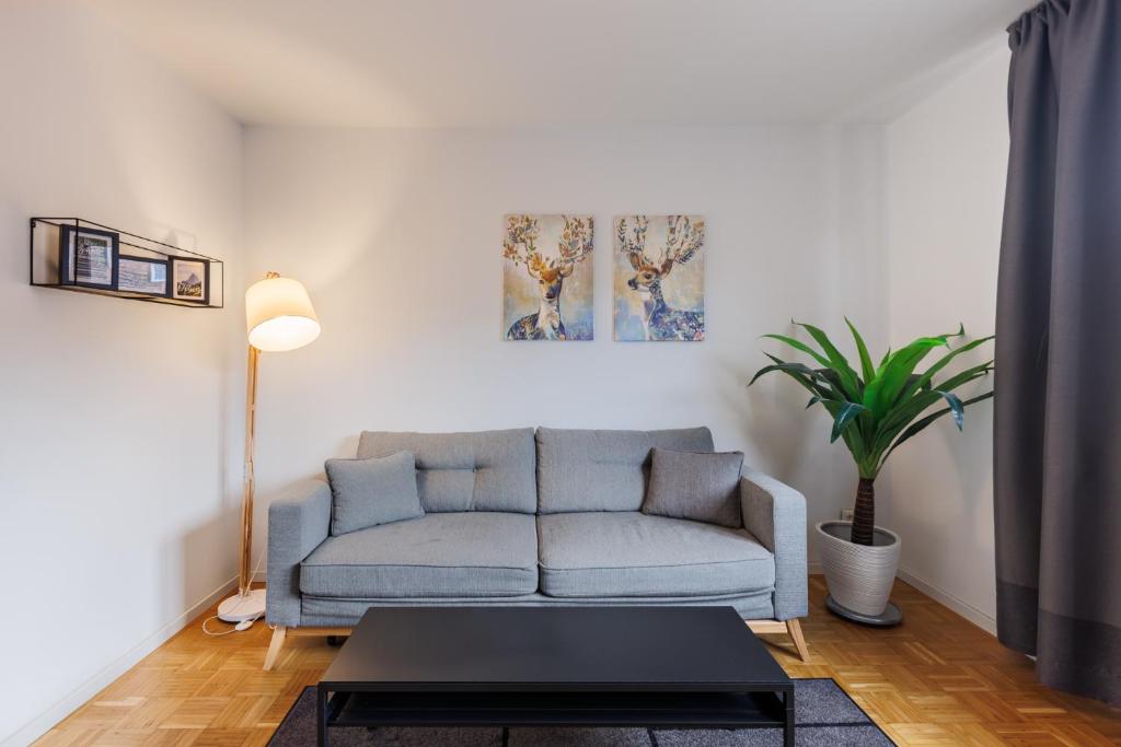a living room with a couch and a table at Glück Auf Appartements Kammerstr. Duisburg in Duisburg