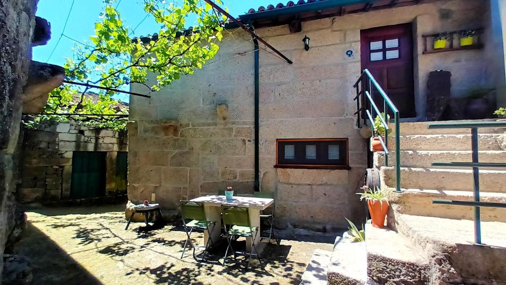 a table in the courtyard of a building at 2 bedrooms house with furnished terrace and wifi at Lindoso 