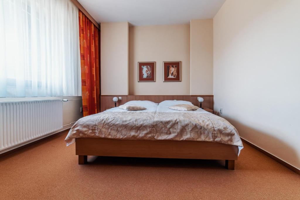 Postel nebo postele na pokoji v ubytování Hotel Stupka