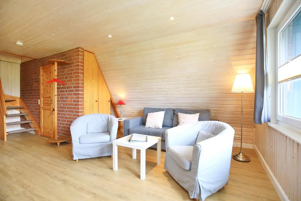 a living room with two chairs and a table at An der Steilküste Finnhütte 04 in Boltenhagen