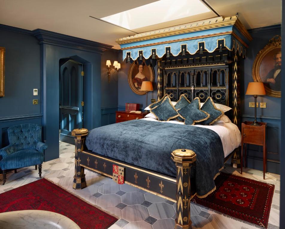 a bedroom with a large bed with blue walls at Batty Langley's in London