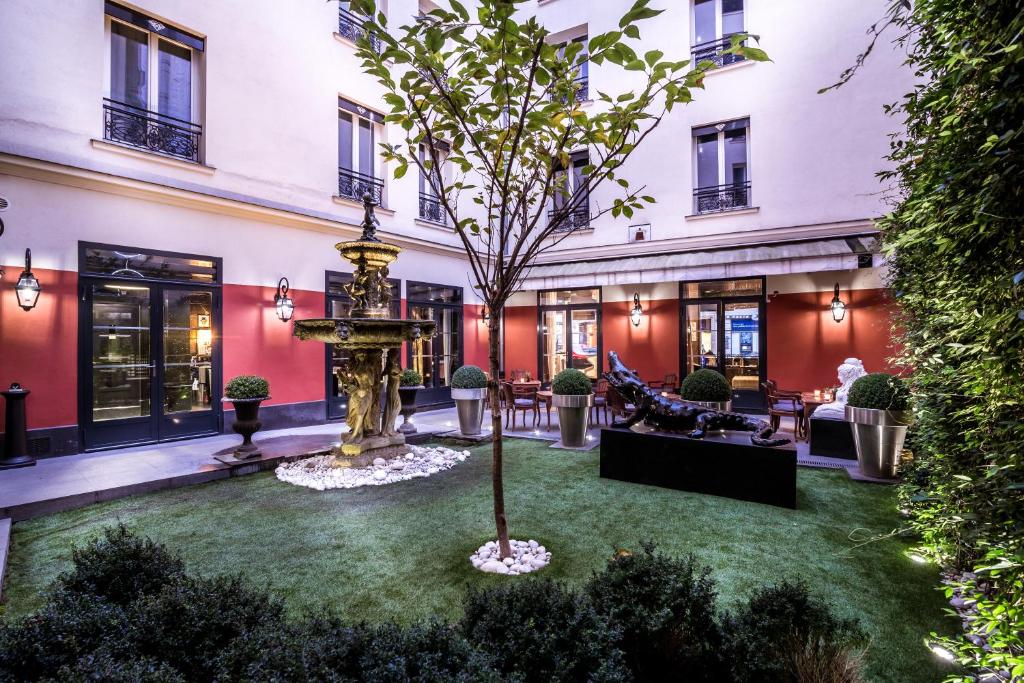 a restaurant with tables, chairs, and umbrellas at Maison Albar Hotels Le Diamond in Paris