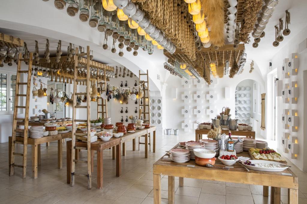 a room with tables with dishes on them at Borgo Egnazia in Savelletri di Fasano