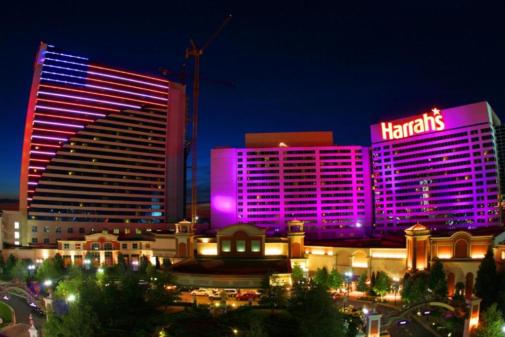 a group of buildings lit up in purple lights at Harrah's Resort Atlantic City Hotel & Casino in Atlantic City