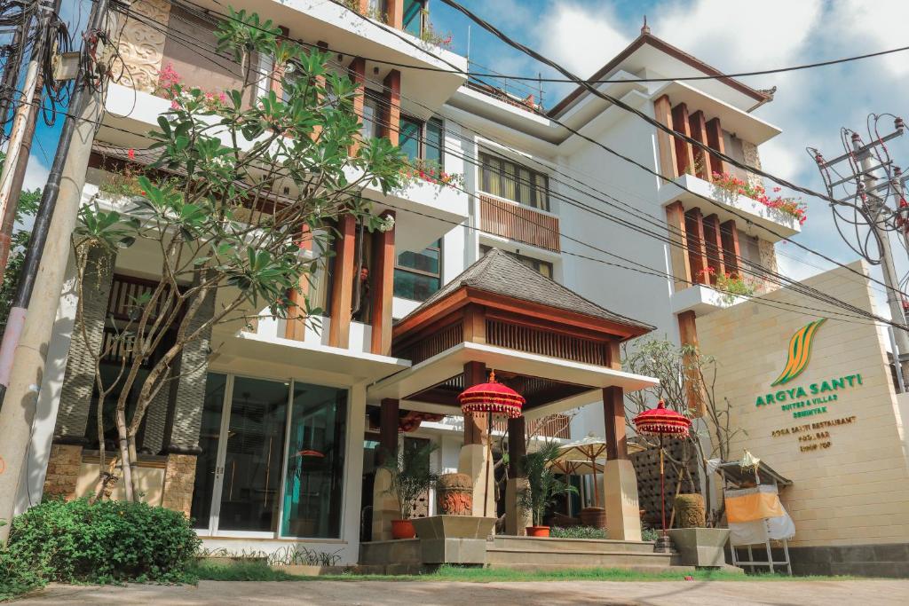 a building with red lanterns in front of it at Argya Santi Suite and Villas in Seminyak