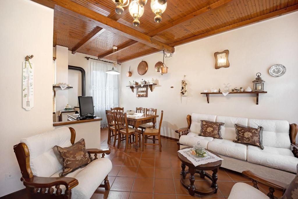 a living room with a couch and a table at Agriturismo U' Spigu in Garlenda