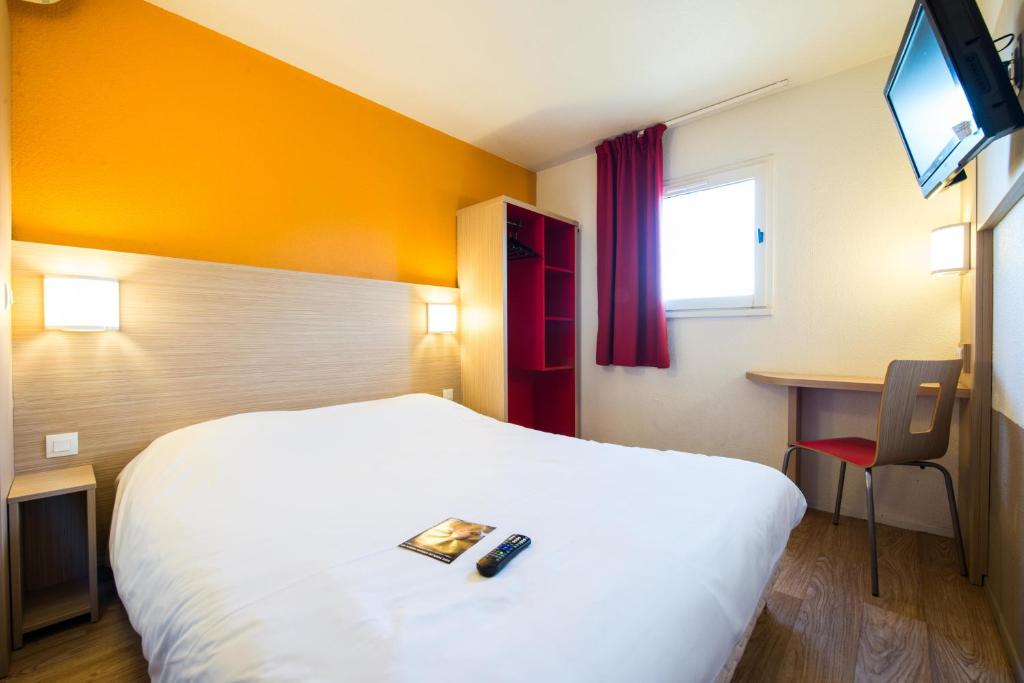 Postel nebo postele na pokoji v ubytování Hôtel Kennedy Parc des Expositions