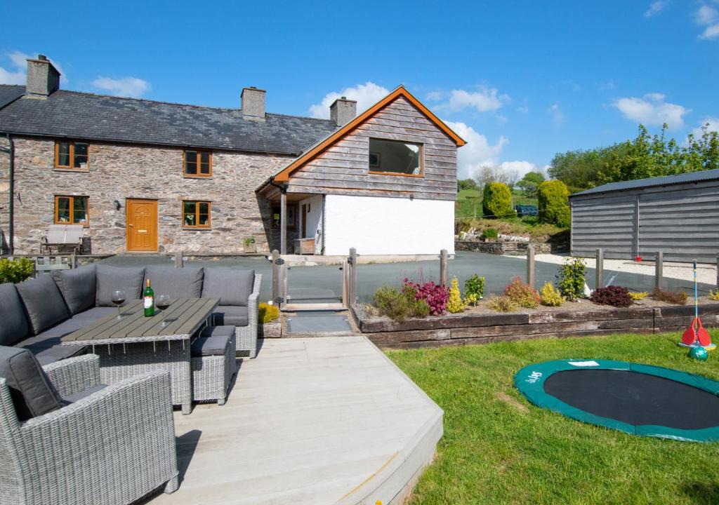a garden with a patio and a house at Hafod Gau in Cemmaes
