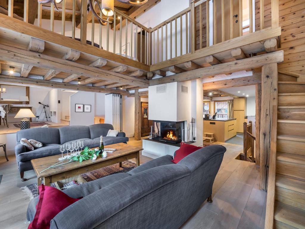 a living room with couches and a fireplace at Chalet Courchevel, 7 pièces, 13 personnes - FR-1-568-1 in Courchevel