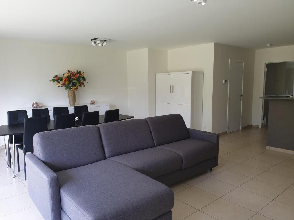 a living room with a couch and a table at Botticelli in Koksijde