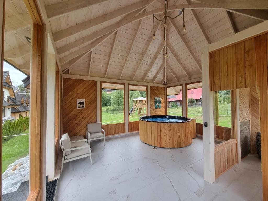 a large room with a pool in the center of a house at Domki Nad Potokiem in Murzasichle