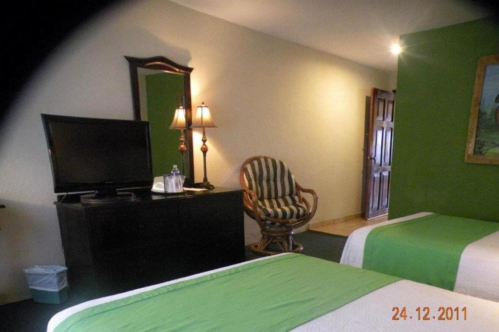 Postel nebo postele na pokoji v ubytování Apart Hotel La Cordillera