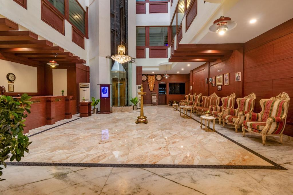 a large lobby with chairs and a waiting room at Zip By Spree Hotels Mangala Towers Thrissur in Trichūr