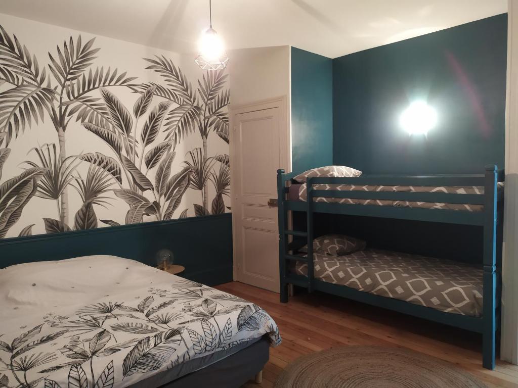 a bedroom with two bunk beds and a wall mural at L'Echappée Belle in Chartres