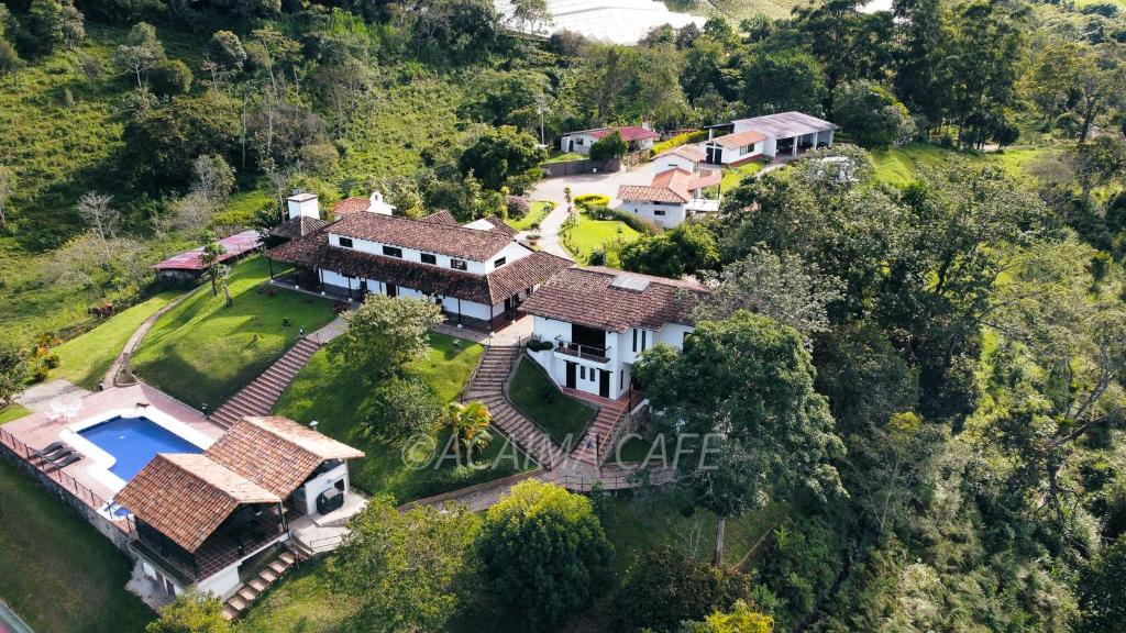 an aerial view of a house with a swimming pool at Acaima Café Lodge in Sasaima