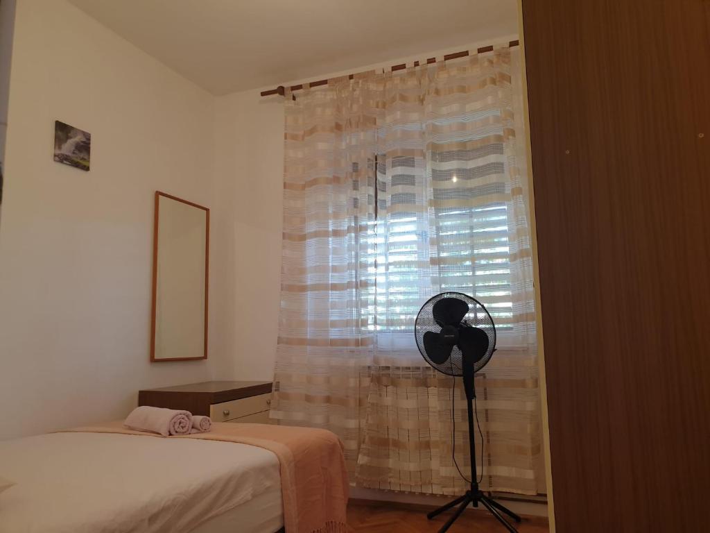 Postel nebo postele na pokoji v ubytování Apartments Ivana