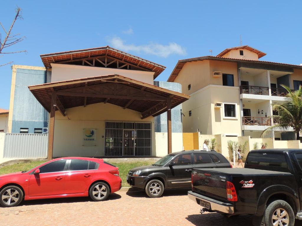 two cars parked in a parking lot in front of a house at Ap Luxo 208 e 207 Prox Beach Park in Aquiraz