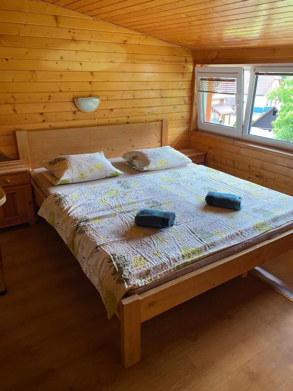 a bedroom with a bed in a wooden cabin at Apartmán Drievko in Terchová