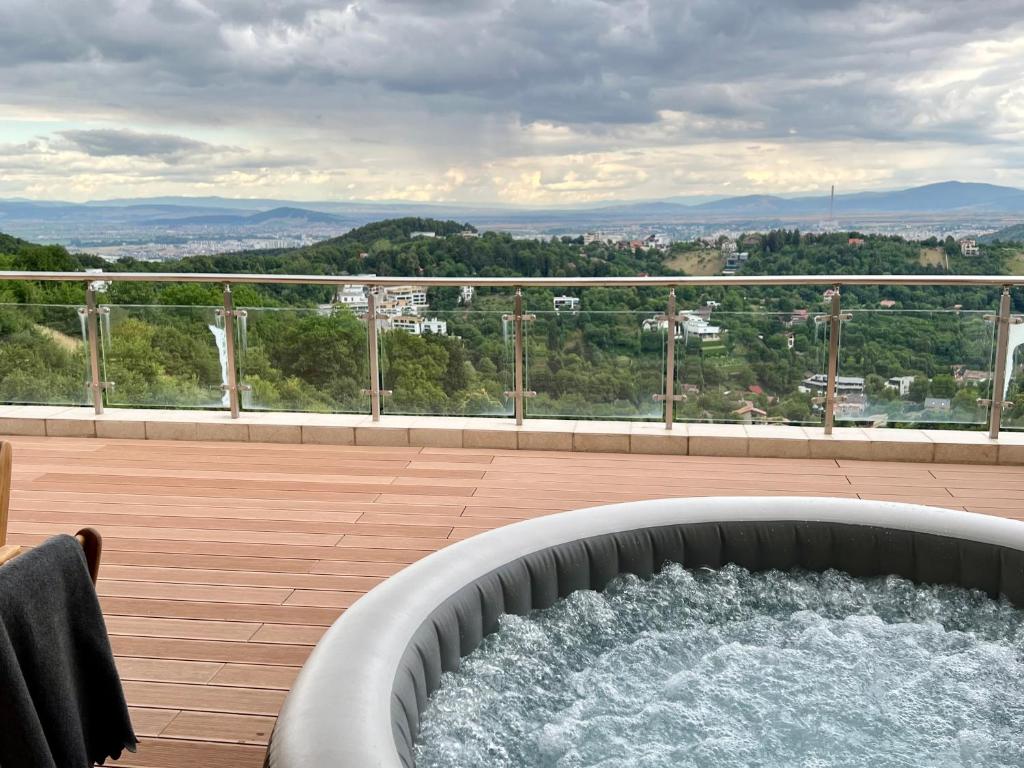 a hot tub on a balcony with a view at #3 CoroNi Seasons Apart in Braşov