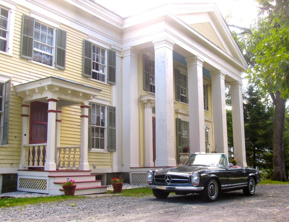 a black car parked in front of a house at Oakcliff Bed and Breakfast in Halfmoon