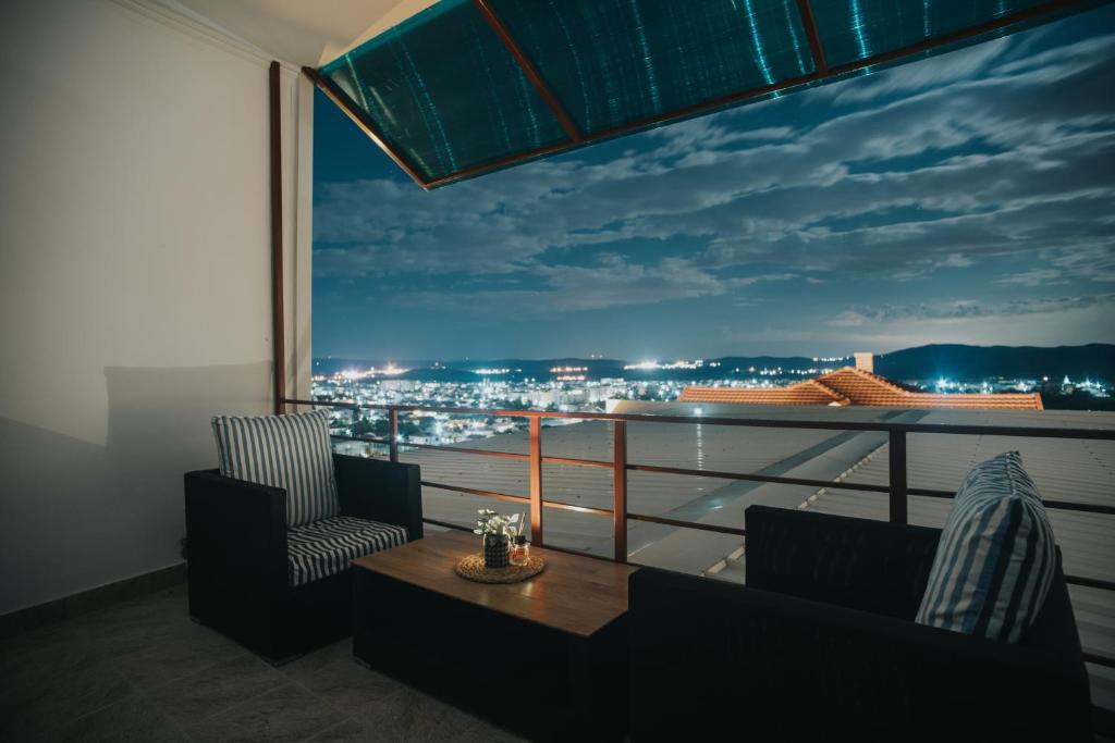 a balcony with a view of a city at night at Panorama Apartments in Gevgelija