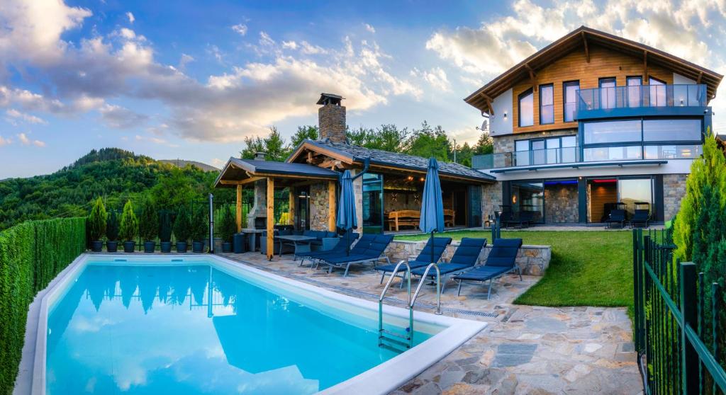 a house with a swimming pool in front of a house at Вила Рустик / Villa Rustic in Kyustendil
