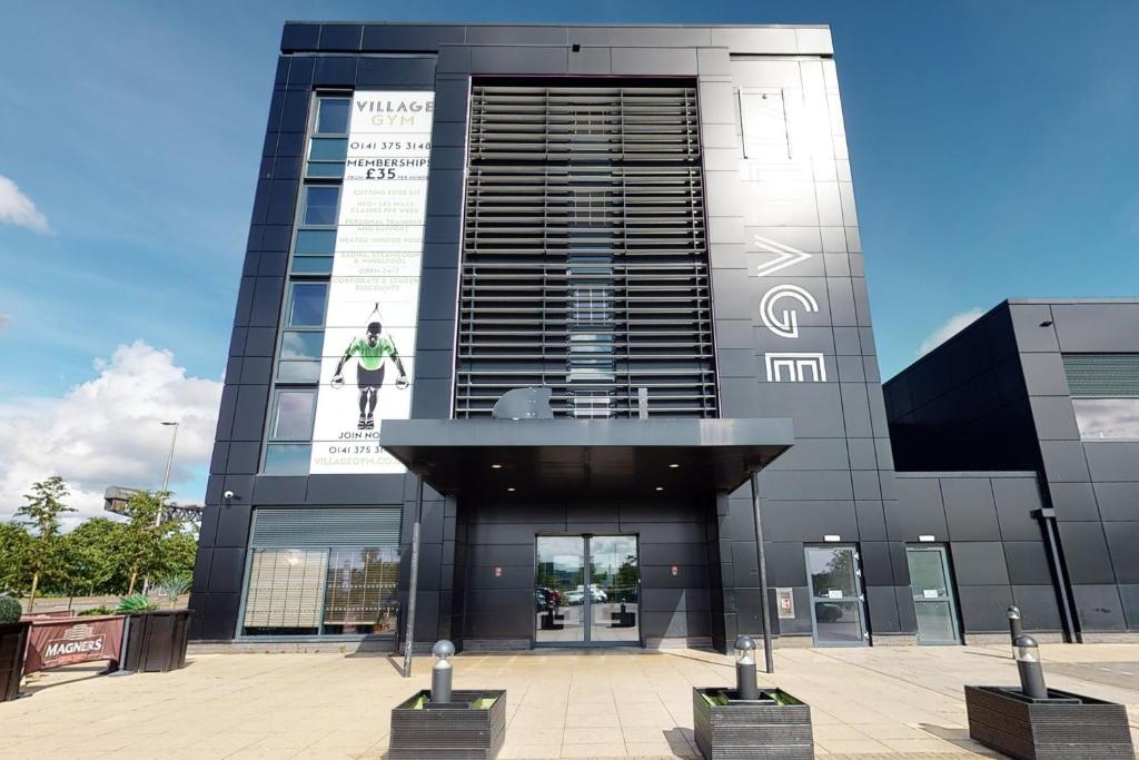 a building with a sign on the side of it at Village Hotel Glasgow in Glasgow