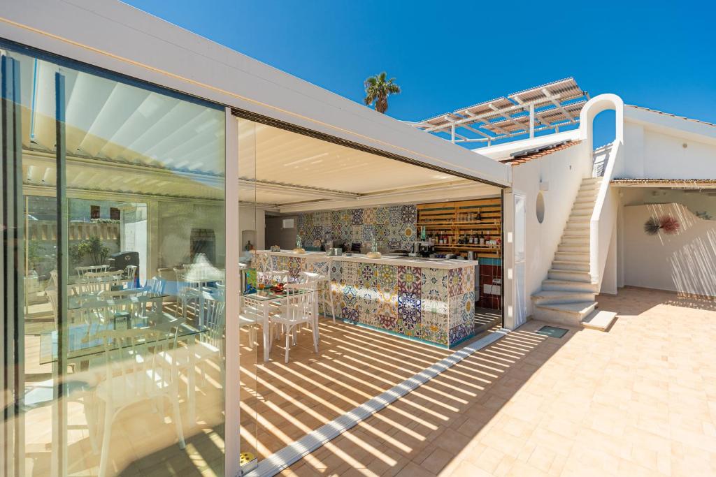 a house with a large glass extension with a patio at Don Leonardo - pool and wellness in Polignano a Mare